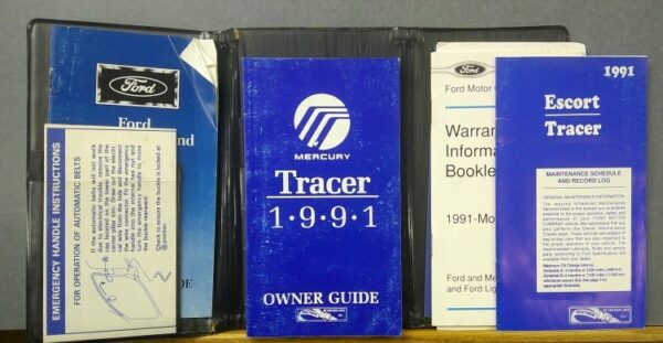 1991 | Merrick Auto Museum Row of old car owner manuals on a shelf: Ford and Mercury Tracer booklets from the 1990s in blue covers.