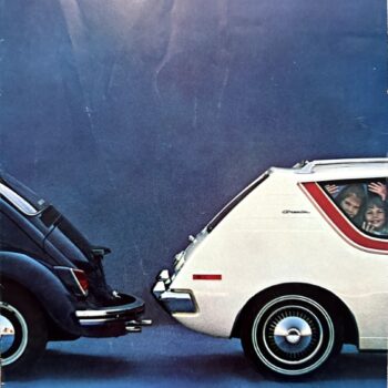 Two cars bumper-to-bumper in a humorous ad; a dark blue car on the left noses against a white Gremlin on the right, passengers visible through the window waving.