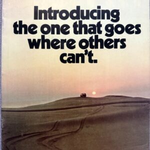Book cover with bold black text: 'Introducing the one that goes where others can't' over a desert landscape at sunset, small car on a hill in the distance