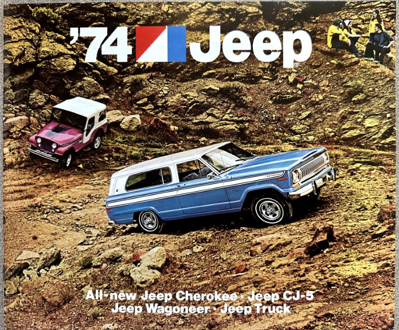 IMG_5470 | Merrick Auto Museum 1974 Jeep brochure cover showing a blue Jeep Wagoneer on rocky terrain with a pink jeep in the background and the '’74 Jeep' headline at the top. Models listed at the bottom.