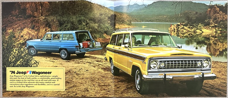 IMG_5471 | Merrick Auto Museum Two vintage Jeep Wagoneers, blue and yellow, parked on a dirt lakeside with rocky hills in the background, from a 1974 Wagoneer ad.