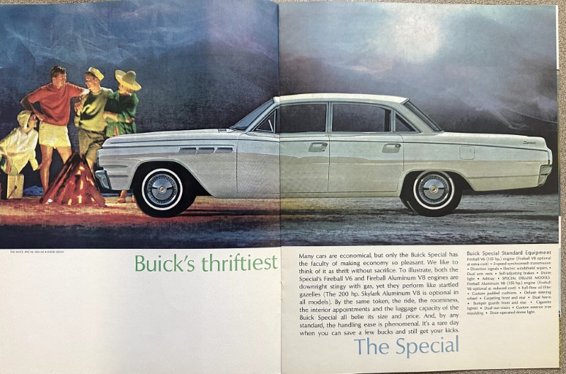 IMG_5585 | Merrick Auto Museum Vintage Buick ad: a long white car across a two-page spread, with people around a campfire on the left and a mountainous backdrop on the right, captioned 'Buick's thriftiest' and 'The Special'.