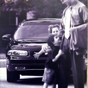 1999 Regal by Buick advertisement: a dark Buick Regal on a street with a man in a suit hugging two children.