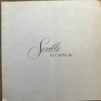 Cream cover with elegant script text reading 'Seville by Cadillac' centered on page, suggesting a Cadillac Seville booklet or brochure.