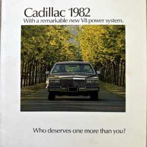 Cadillac 1982 advertisement featuring a classic car on a tree-lined road with the slogan “Who deserves one more than you?”