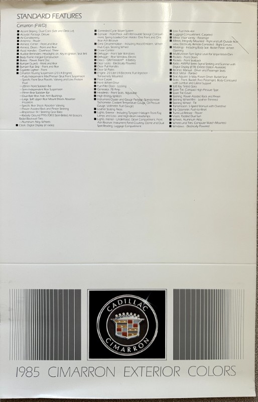 IMG_5808 | Merrick Auto Museum 1985 Cadillac Cimarron exterior colors page with a 'Standard Features' list, Cadillac crest, and barcodes at the bottom.