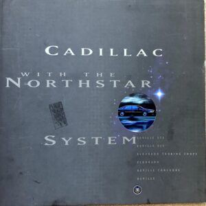 Cadillac brochure cover reading 'With the Northstar System' with a round image of a blue car and starry accents on a dark background.