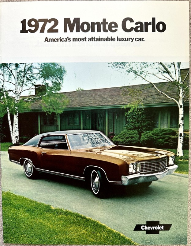 IMG_5910 | Merrick Auto Museum Advertisement poster for 1972 Monte Carlo: brown Chevrolet Monte Carlo parked on a suburban driveway; slogan 'America’s most attainable luxury car.'
