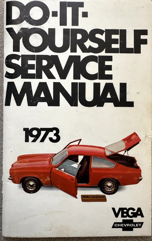 IMG_5961 | Merrick Auto Museum Cover of a 1973 Do-It-Yourself Service Manual by Vega Chevrolet, featuring a red car with open doors and trunk on a white background.