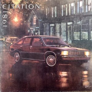 Vintage 1981 Citation sedan on a rain-soaked city street at night, storefronts glowing in the background.