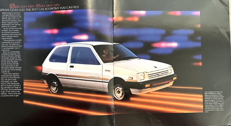 IMG_6108 | Merrick Auto Museum White compact hatchback driving at speed with neon light streaks behind, in a magazine ad.