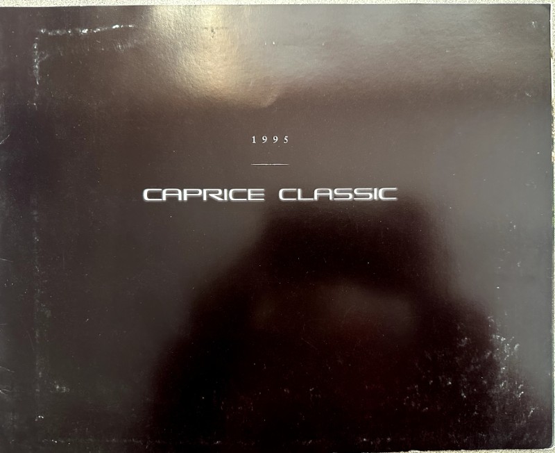 IMG_6161 | Merrick Auto Museum 1995 Caprice Classic brochure cover on a dark, glossy background, with white text.