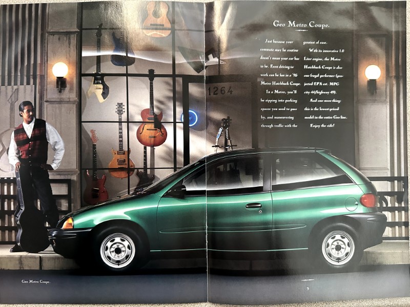 IMG_6221 | Merrick Auto Museum Green Geo Metro Coupe on display in a music-themed showroom with guitars on the wall and a man in a red vest standing beside it, as part of an ad spread.