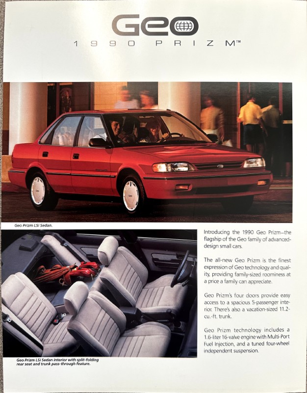 IMG_6225 | Merrick Auto Museum Red Geo Prizm LS sedan photographed from the side in front of a building with blurred pedestrians in the background