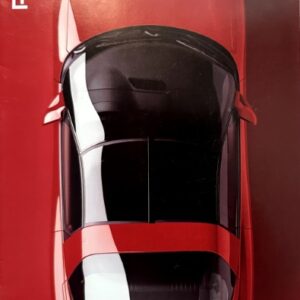 Top-down view of a red Pontiac car on a brochure cover, with Pontiac branding along the left edge and 'We are driving excitement' slogan on the right edge.