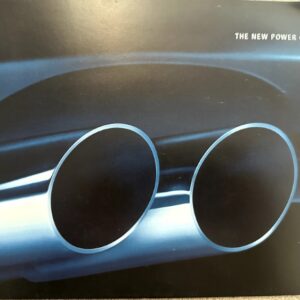 Close-up of chrome dual exhaust pipes on a Pontiac car with the slogan 'The New Power of Pontiac 2004' in the corner.