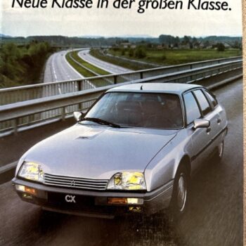 Advertisement for the Citroën CX: a silver sedan on a highway; headline reads 'Der neue CX. Neue Klasse in der großen Klasse.'
