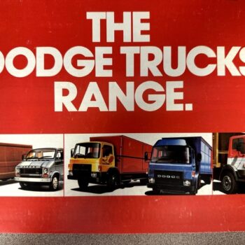 Advertisement banner with bold white text 'THE DODGE TRUCKS RANGE' and lineup of colorful Dodge trucks below.