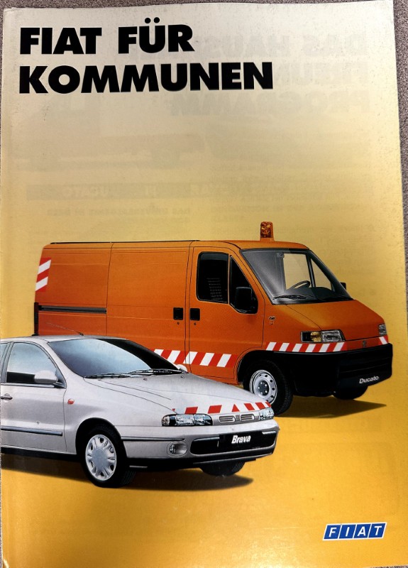 IMG_7504 | Merrick Auto Museum Fiat brochure cover with a silver car and an orange van that has diagonal red‑and‑white safety stripes; title reads 'FIAT FÜR KOMMUNEN'.