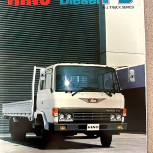 Front view of a white Hino FD 4x2 truck parked in front of a modern building, with bold 'HINO Econo Diesel FD' branding above.