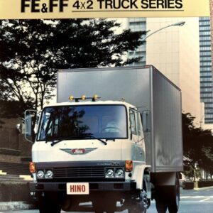 1984 Hino Econo Diesel FE&FF 4x2 box truck driving on a city street with a large cargo box and bold model banner above.