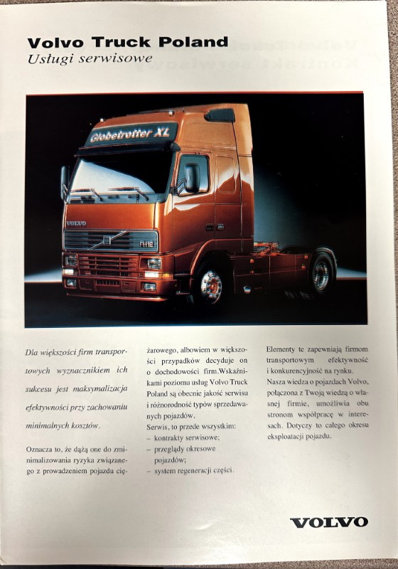 IMG_8688 | Merrick Auto Museum Orange Volvo truck photographed on a brochure page titled 'Volvo Truck Poland' with Polish text columns nearby.