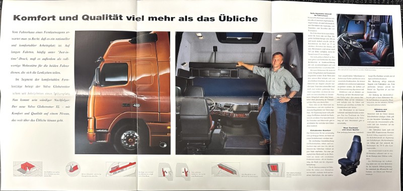 IMG_8698 | Merrick Auto Museum Anzeige für Komfort und Qualität: orange LKW-Kabine von der Seite, Innenraum mit Mann am Lenkrad und Arm auf der Mittelkonsole; Slogan oben.