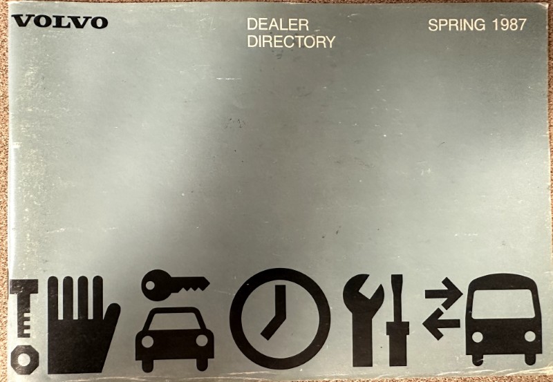 IMG_8706 | Merrick Auto Museum Volvo Dealer Directory Spring 1987 cover with a row of black icons (hand, key, car, clock, wrench, arrows, car).