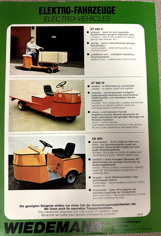 IMG_8739 | Merrick Auto Museum Page from a Wiedemann electro-vehicles brochure showing three orange electric vehicles with German product notes on a green background