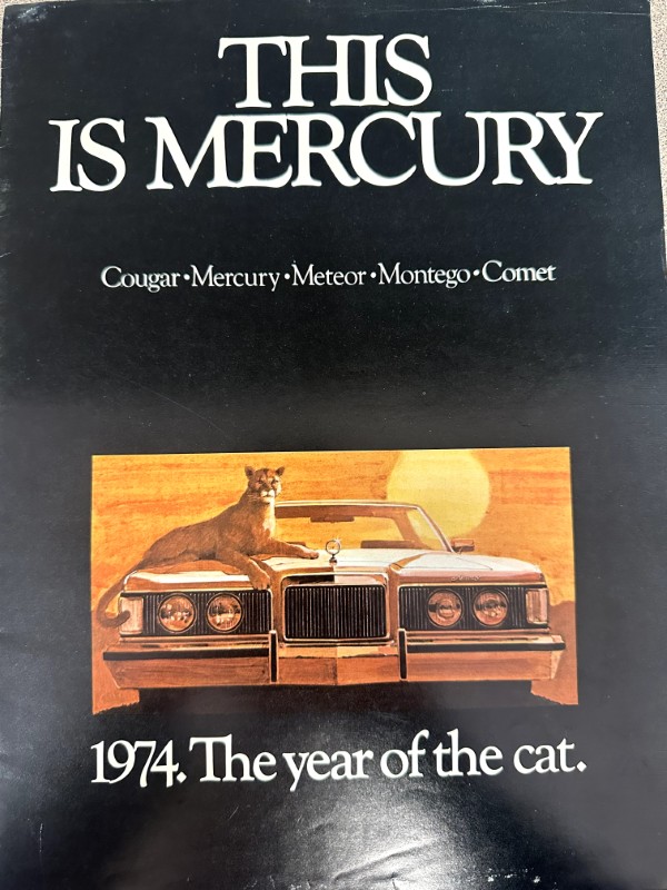 IMG_8979 | Merrick Auto Museum Book cover reading ‘THIS IS MERCURY’ with a vintage car and a cat on the hood at sunset; caption: 1974, ‘The year of the cat.’