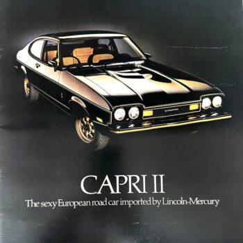 IMG_8991 | Merrick Auto Museum Capri II coupe with black body and tan interior; brochure cover with the model name Capri II and the tagline about a European road car imported by Lincoln-Mercury.