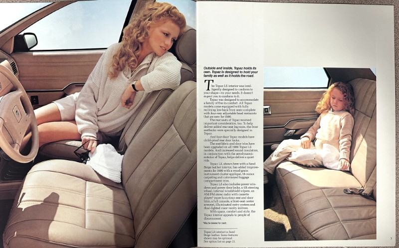 IMG_9059 | Merrick Auto Museum Woman with wavy blond hair in a light sweater sits in a beige leather car interior; a child sits in the back seat on the adjacent page.