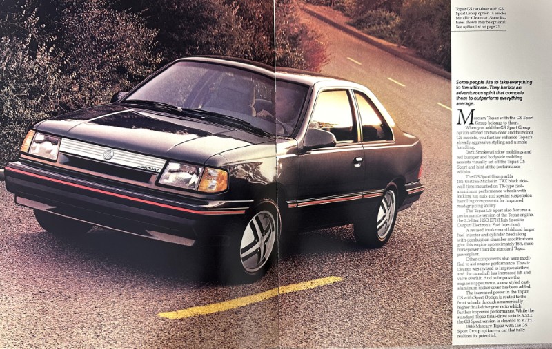 IMG_9060 | Merrick Auto Museum Front three-quarter view of a black and gray compact sedan with a red stripe along the side, parked on a rural road for a magazine spread.