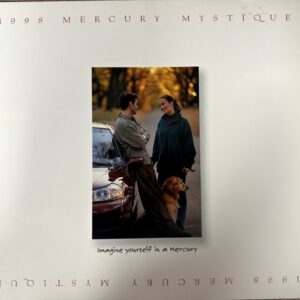 Two adults with a dog stand by a car in a park during fall; Mercury ad reads 'Imagine yourself in a Mercury' (1998).