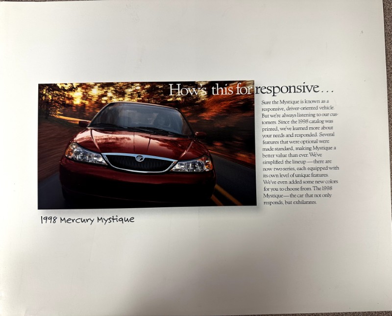 IMG_9125 | Merrick Auto Museum Red 1998 Mercury Mystique driving on a road, with the headline “Hows this for responsive…” and a text column on the right.