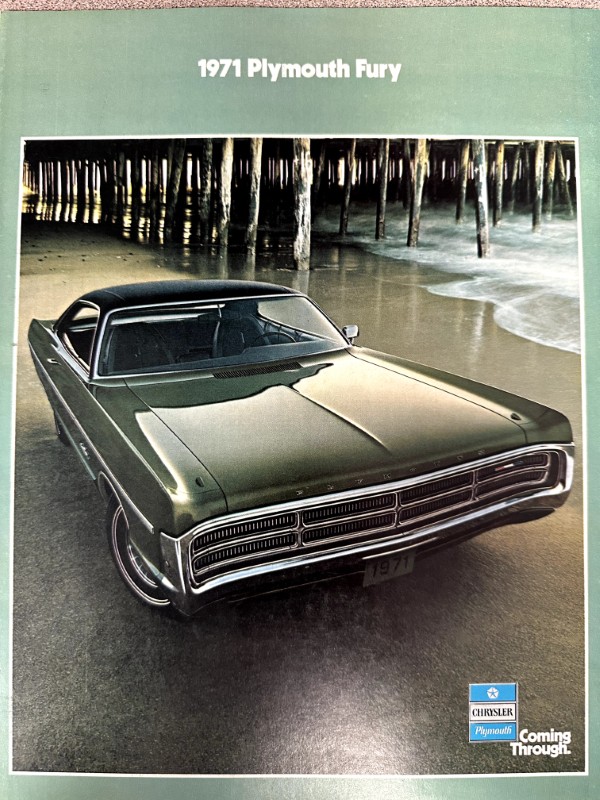 IMG_9205 | Merrick Auto Museum Green 1971 Plymouth Fury parked on a beach under a wooden pier; brochure cover image with Chrysler Plymouth branding in the corner