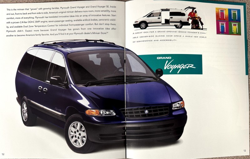 IMG_9282 | Merrick Auto Museum Dark blue Grand Voyager minivan in a three-quarter front view spanning a two-page spread with text and a small inset image of a white van.