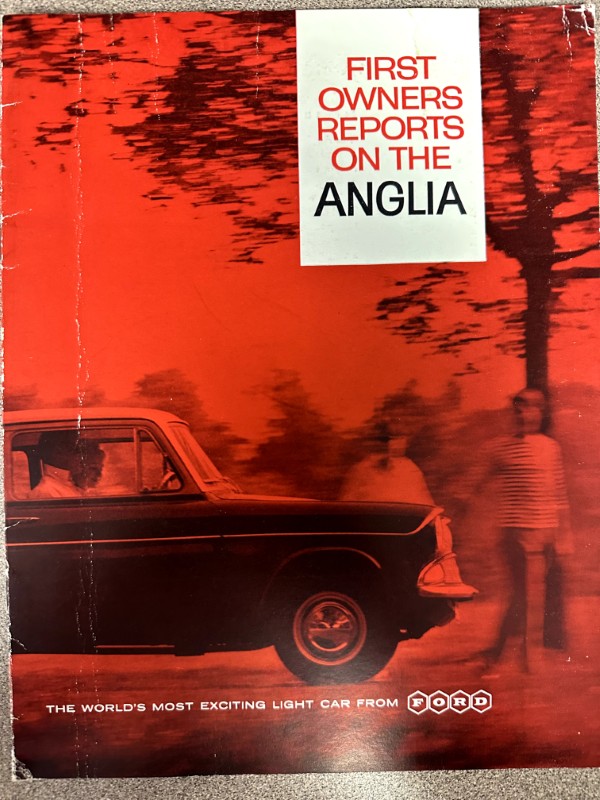 IMG_9356 | Merrick Auto Museum Advertisement cover for Ford Anglia: red-tinted photo of a classic car with two people nearby and the headline 'FIRST OWNERS REPORTS ON THE ANGLIA' in bold white panel.