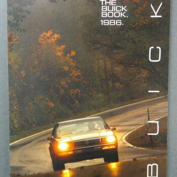 Book cover with a gold Buick on a wet, winding road and autumn trees; top-right reads 'THE BUICK BOOK. 1986.'