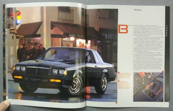 2 Custom | Merrick Auto Museum Dark green Pontiac Regal sedan on a wet city street at night, with storefronts and pedestrians in the background.