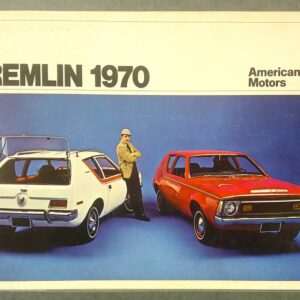 Advertisement for the 1970 AMC Gremlin showing two Gremlins (white and red) with a man in a tan jacket standing between them against a blue backdrop.