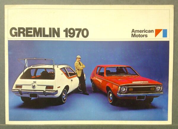30 Custom | Merrick Auto Museum Advertisement for the 1970 AMC Gremlin showing two Gremlins (white and red) with a man in a tan jacket standing between them against a blue backdrop.