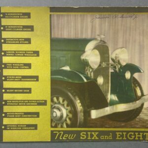 Vintage Oldsmobile advertisement box showing a green classic car and a tall yellow feature list labeled NEW SIX AND EIGHT on the right side and a handwritten signature at the top edge.