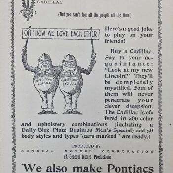 Two cartoon men in overalls hold up a banner that reads 'OH! HOW WE LOVE EACH OTHER' in a vintage Cadillac advertisement framed by a decorative border.
