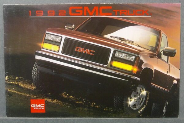 7 Custom | Merrick Auto Museum 1992 GMC Truck brochure cover showing a brown pickup at an angle with the GMC emblem on the grille in focus.