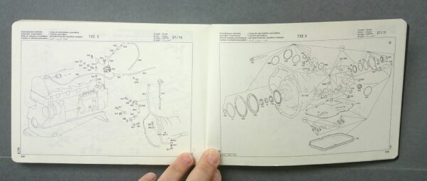 Blk3 Custom | Merrick Auto Museum Open manuals showing exploded diagrams of engine components on two pages, with labeled parts and assembly lines, including seals and housings.