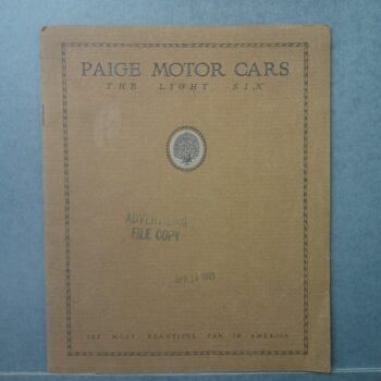 DSCF0035 Custom | Merrick Auto Museum Cover of a vintage Paige Motor Cars brochure for 'The Light Six' with a decorative border and central seal, on a blue background.