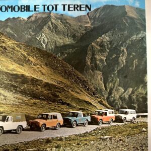 Six vintage off-road vehicles in a row on a mountain road with rugged peaks in the background; ad banner reads 'AUTOMOBILE TOT TEREN'.