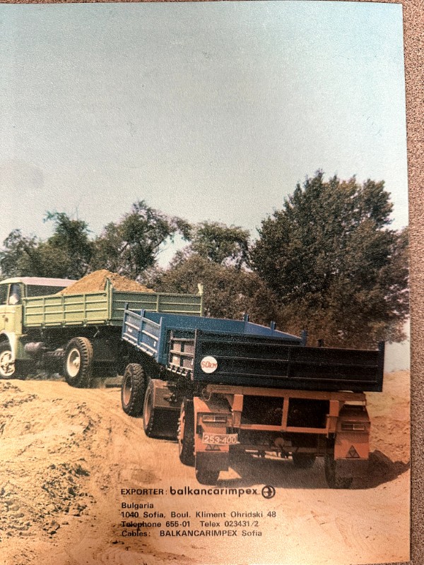 IMG_9569 | Merrick Auto Museum Two dump trucks on a dirt mound with trees in the background; bottom shows Balkancarimpex exporter contact details.