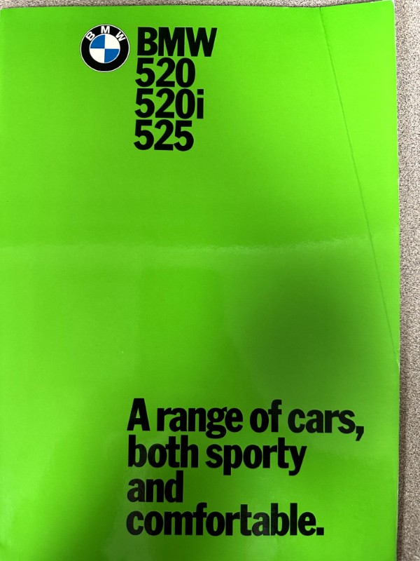 IMG_9655 | Merrick Auto Museum Bright lime green BMW brochure cover with the roundel logo and model numbers 520, 520i, 525 at the top and the tagline 'A range of cars, both sporty and comfortable.'